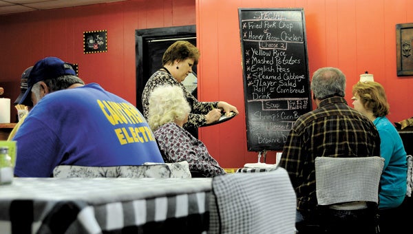 Ann Edwards, co-owner of Emily’s Café, takes an order during the restaurant's lunch rush. Emily’s Café’s Cranberry nut salad with balsamic dressing was listed as one of the “100 Dishes to Eat in Alabama Before You Die” and is feature in a new photo book titled Alabama Food. File Photo