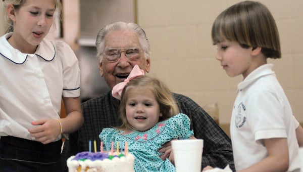 Gene Hardin gets a little help blowing out his birthday candles from his grandchildren Caroline Hardin and Will Hardin and great-granddaughter Kate Coles. Hardin was treated to a surprise birthday party Monday by the Greenville Lions Club. Hardin turns 90 today.  (Advocate Staff/Andy Brown)