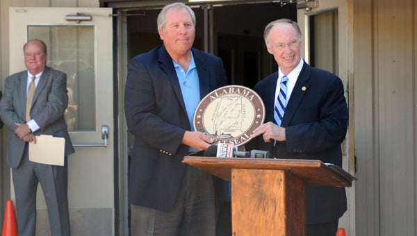 Gov. Robert Bentley, right, presents Ozark Materials President Lee Gross, left, with an Alabama seal Thursday following an announcement that the company will open a plant in Greenville. (Advocate Staff/Andy Brown) 