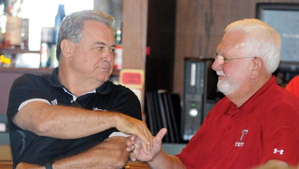 Troy University head football coach Larry Blakeney, left, shakes hands with Jimmy Gardner, right, prior to speaking at the Trojan Tour stop at Greenville’s Cambrian Ridge on Thursday. (Advocate Staff/Jonathan Bryant)
