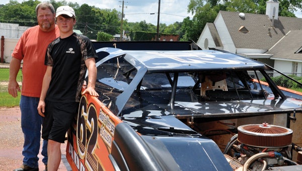 Randy Adams and his son, Andrew, show off Randy's Late Model Crate race car at Randy's Wrecker & Collision in Fort Deposit. Both Randy and Andrew race Late Models at the Butler County Motorsports Park in Greenville. (Advocate Staff/Fred Guarino)
