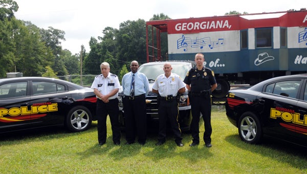 The Georgiana Police Department recently added a Chevrolet Tahoe and two Dodge Chargers to its fleet of nine patrol vehicles at a cost of approximately $75,000. Pictured with the new vehicles are, from left to right, Chief James Blackmon, Mayor Jerome Antone, Assistant Chief Isaac Ward and Officer Jason Blue. (Advocate Staff/Andy Brown)