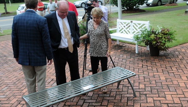 Greenville Mayor Dexter McLendon and Janice McLendon read the inscription on the bench presented to them by officials with Baptist Medical Center South in Montgomery. (Advocate Staff/Andy Brown)