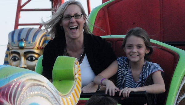 Vickie Russell and Kaylee Russell are all grins as they ride a rollercoaster at the 59th annual Butler County Fair. This year’s fair will open Wednesday and run through Saturday. (File Photo)