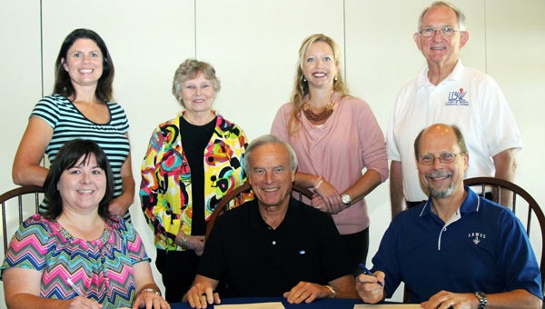 The LBW Community College Foundation recently established an endowed scholarship in honor of Seth Hammett, LBWCC president emeritus.  Pictured signing the agreement are, from left, LBWCC Foundation President Kim Carter; Hammett; and LBWCC President Dr. Herb Riedel. Also attending were, standing from left, Shannon Jackson, Foundation secretary/treasurer; board members Dr. Jean Thompson and Jennifer Curry; and LBWCC Vice President Dr. Jim Krudop. (Courtesy Photo) 