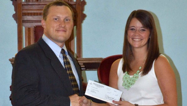 Fort Dale Academy graduate Taylor Merry was recently presented with a scholarship from the Eureka Lodge #64.  Pictured presenting Merry with the scholarship is Chad Edwards, secretary of Eureka Lodge #64. (Submitted Photo)