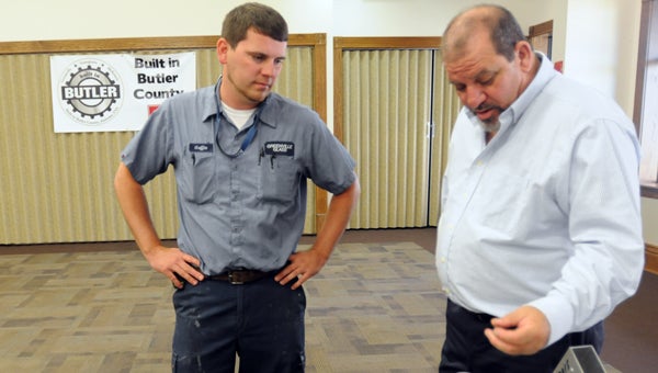Griffin Huggins, left, learns about the products produced by REF Alabama Inc., from John Jernigan, project manager at  REF Alabama. (Advocate Staff/Andy Brown)