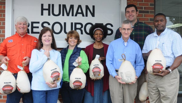 The Camellia Longbeards donated 12 turkeys Friday to the Butler County Department of Human Resources to aid families in need during  Thanksgiving. Pictured are, from left to right, Ronnie Graddy, Kisa Butts, Rebecca Butts, Wanda Coleman, Tom Nicholas, Todd Campbell and Tommie Means. (Advocate Staff/Andy Brown)