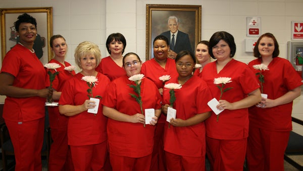 Reid State Technical College held a pinning and candle lighting ceremony for graduates of the school’s phlebotomy program on Dec. 12 in the Wiley Salter Auditorium on the Evergreen campus. Greenville’s Cynthia Chambliss was recognized for having the highest GPA among the graduates. Pictured are, front row, from left to right, Cynthia Chambliss, Greenville; Kasey Marie Dykes, Brewton; Brittany Ceria Simon, Evergreen; and Brandi Leanne Smith, Greenville. Back row, from left to right, LaBrinka N. Wallace, Evergreen; Kellie Lynn Emmons Vargas, Evergreen; Kathryn Debra Floyd, Brewton; Tanya R. Busch, Andalusia; Ashley N. Richey, Greenville; and Ashley Hamby Pipken, Evergreen. (Submitted Photo)