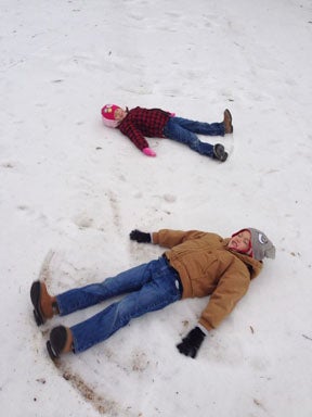Bryant and Julia Ballew make snow angels on Tuesday. (Courtesy Photo)