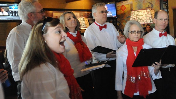 From left to right, April Lowery, Tom Payne, Gerri McGinnis , David Norrel, Liz Mullins and Tommy Ryan perform Stevie Wonder’s “I Just Called To Say I Love You” to diners at Ruby Tuesday on Friday. (Advocate Staff/Andy Brown)