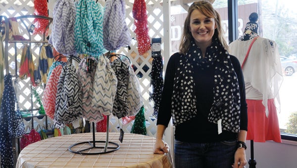 Tonya and Dennis Crowe and family recently opened Infinity, a boutique and gift shop, in the old Kate’s Kountry location. Tonya Crowe is pictured with a selection of scarves available at the store. (Journal Staff/Kendra Bolling)