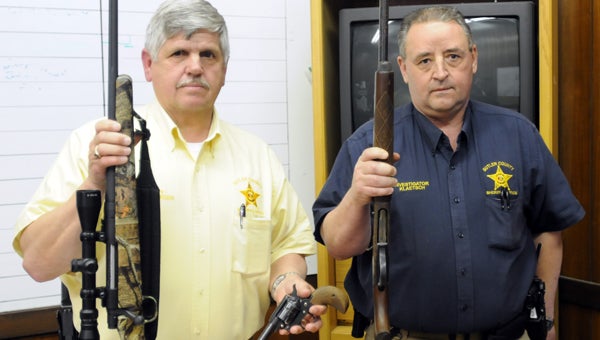 Butler County Sheriff Kenny Harden, left, and Investigator Sean Klaetsch, right, pose with guns recovered after the BCSO solved a string of burglaries. (Advocate Staff/Andy Brown)