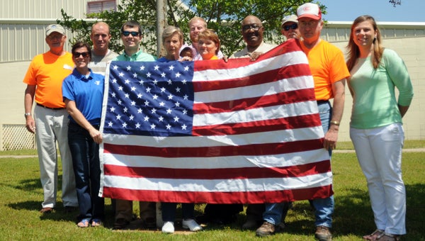 The Camellia City Civitans donated an American flag to the Greenville YMCA on Friday. The club made the donation in an effort to promote patriotism in the community. Pictured are, from left to right, Lomax Owns, YMCA Director Tina Caver, Allen Peterson, Justin Pierce, Susan Murphy, Quinn Sexton, Marty Sexton, Joann Mathews, Jeddo Bell, Jimmy Russell, Terry Gafford and Alicia Sexton. (Advocate Staff/Andy Brown)