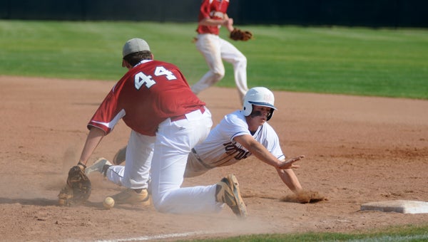 Fort Dale Academy's James Burkett dives back into first base during the Eagles' 6-4 win over Escambia Academy Thursday. (Advocate Staff/Andy Brown)