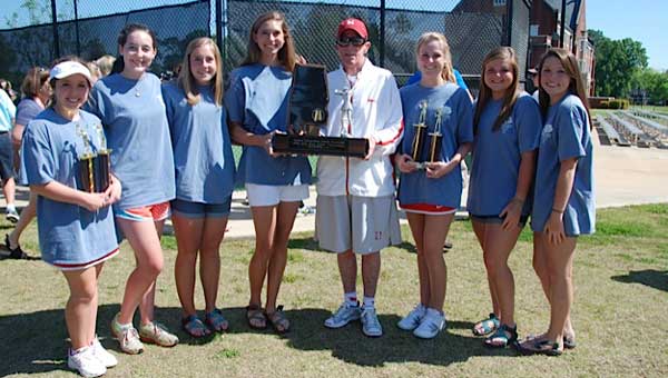 Huntington coach Charlie Lane presents trophies to the FDA girls tennis team.  Members include (from left to right) Mary Claire Carlton, Anna Wright, Madison Ann Gaston, Ashton Scott,  Marion Lightfoot, Sara Elizabeth Owens and Jennifer Grace Arnold.
