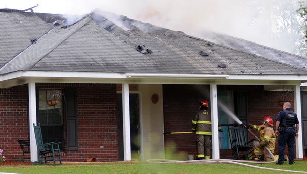Firefighters with the Greenville Fire Department battle a blaze at a house on Fort Dale Road Tuesday morning. When first responders arrived on the scene flames were shooting from the roof of the house. (Advocate Staff/Andy Brown)