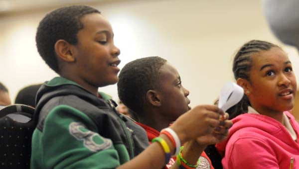 From left to right, Greenville Elementary School students Christopher Robinson, Quaeshun McMeans and Taimane Lawson construct Möbius strips during a demonstration at LBW Community College on Thursday. (Advocate Staff/Andy Brown)