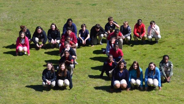 The 7th grade pre-algebra class at Greenville Middle School recently celebrated Pi Day with a variety of activities including constructing a “human pi symbol.” (Submitted Photo) 