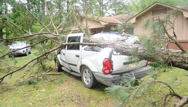 Tuesday morning’s storm caused a tree to fall on an SUV parked in front of a home on Starlington Road in Georgiana. (Advocate Staff/Tracy Salter)