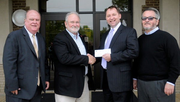 Southeast Alabama Gas District made a $13,000 contribution to the Butler County Commission for Economic Development.  The funds help aid the BCCED recruit new industries and businesses to the area. Pictured, from left to right, are Mayor Dexter McLendon, BCCED Executive Director David Hutchison, Director of Economic Development for SEAGD Wiley Lott, and Cleve Poole, chairman of the BCCED. (Advocate Staff/Tracy Salter)