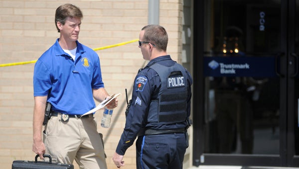 Lt. Justin Lovvorn, left, and Sgt. Andy Beck, right, responded to a bank robbery at Trustmark Bank on the Greenville Bypass. (Advocate Staff/Andy Brown)