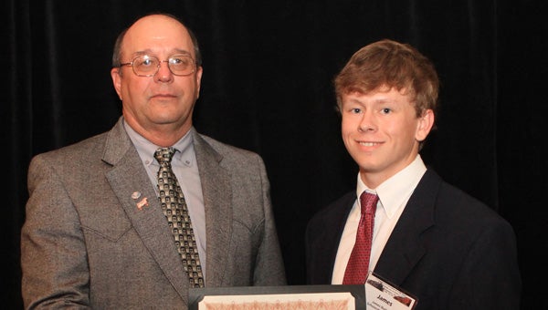 James Burkett was presented with an Alabama Cattlemen’s Foundation Scholarship at the 71st Annual Alabama Cattlemen's Association Convention and Trade Show in Montgomery. He is pictured accepting the award from Alabama Cattlemen’s Association Past President Jimmy Holliman. (Submitted Photo)
