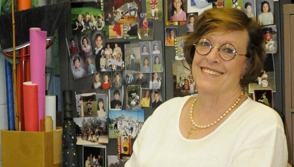 Twenty-six years worth of memories adorn the wall of Mary Dearing’s classroom in all shapes and sizes, but her infamous photo wall contains the most of all.  The wall houses photos of many of her former students. (Advocate Staff/Jonathan Bryant)