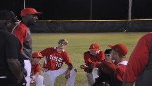 Luverne baseball players, including seniors Taylor Grant (center, left) and Zane Jones (center, right) listen to a post-game speech from head coach Andre Parks after losing twice to Houston Academy in the semifinals. Parks told players the loss will hurt for a time, but they should be proud of their accomplishments.