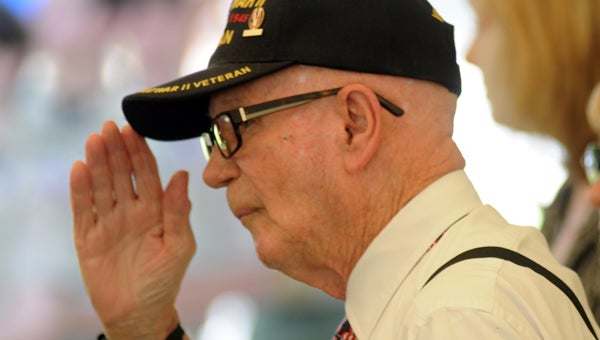 World War II veteran John Little salutes during the playing of the National Anthem at the Greenville Lions Club’s 11th annual Memorial Day Celebration at Confederate Park on Monday. (Advocate Staff/Andy Brown)