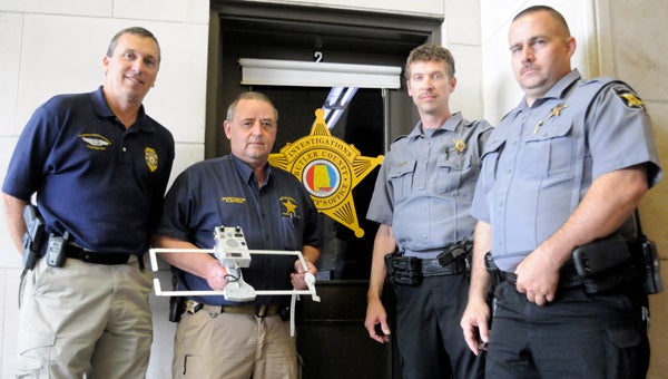 From left to right:  Project Lifesaver state coordinator Kent Smith trained local deputies Sean Klaetsch, James Harville, Matt Merritt and Lenny Lee (not pictured) to become certified responders to locate individuals enrolled in the Project Lifesaver program.  The four deputies took a written and practical exam following the certification process, and the latter involved locating a hidden bracelet with specialized equipment in under 20 minutes. (Advocate Staff/Jonathan Bryant)