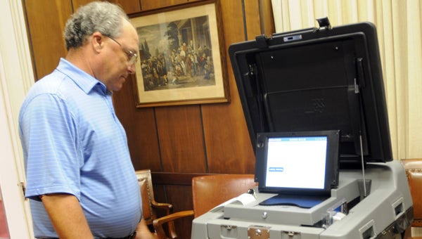 Butler County Probate Judge Steve Norman demonstrates how the county’s new voting machines work. (Advocate Staff/AndyBrown)