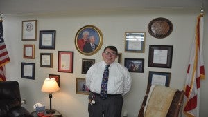 John Wilson, President and Chief Operating officer of Luverne-based Super Foods, stands in front of an office wall filled with awards and recognitions and crowned with a photo of his adoptive father and mother, John E. “Jimmy” and Alyce Wilson. He says his parents’ giving attitude is his inspiration to give selflessly to the community.