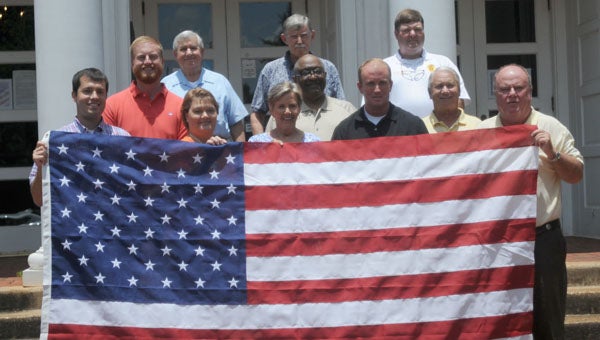 The Camellia City Civitan Club donated an American flag to the City of Greenville on Wednesday. The club made the donation in an effort to promote patriotism in the community. Pictured are, first row from left to right, Justin Pierce, Joann Mathews, Susan Murphy, Allen Peterson and Greenville Mayor Dexter McLendon. Second row, Marty Sexton, Jeddo Bell and Johnny Autrey. Third row, Gene Autrey, Jimmy Russell and Greenville Fire Department Chief Chad Phillips. (Advocate Staff/Andy Brown)