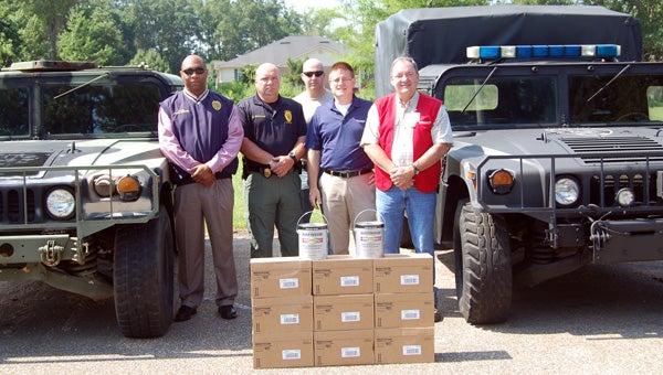 Marvin’s and Rust-Oleum recently donated 20 gallons on paint to the Greenville Police Department be used in the refurbishing several vehicles. Pictured are, from left to right, Capt. Anthony Barganier; Lt. Marcus Christianson; Sgt. Curtis Miller; Jim Doody, Rust-Oleum senior area manager for the Southeast Division; and John Shell, Marvin’s store manager. (Advocate Staff/Morgan Burkett)