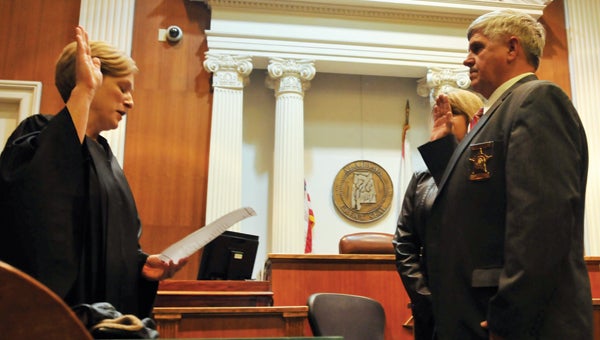 Second Judicial Circuit Court Judge Terri Lovell swears in Butler County Sheriff Kenny Harden for another four-year term Tuesday afternoon inside of the county’s courthouse. Harden is shown here with his wife, Evelyn. Along with Harden, 10 BCSO deputies were also sworn in for another four-year term. | Advocate Staff / Andrew Garner