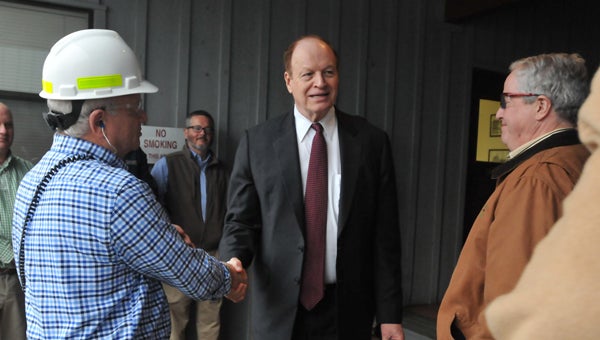 ADVOCATE STAFF / ANDREW GARNER U.S. Sen. Richard Shelby (R-Ala.) (center) shakes hands with employees and community members at Coastal Forest Products in Chapman on Monday.