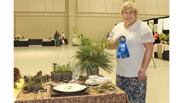A forestry themed place setting earned Cheryl Nelson of Crenshaw County first place and $150 in the State Tablescapes Contest sponsored by the Alabama Farmers Federation Women’s Leadership Division. The contest was part of the Federation’s 43rd Commodity Producers Conference in Montgomery July 30-Aug. 2. For more information about the Federation’s Women’s Leadership Division, visit AlfaFarmers.org. For more photos of the Commodity Conference, visit Flickr.com/AlabamaFarmers.