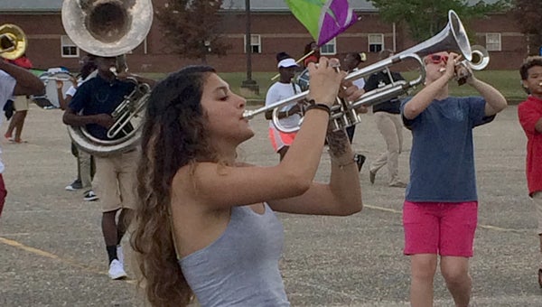 Senior trumpet player Jennyfer Maciel and the Greenville High School Tiger Pride Marching fine-tune their halftime show, which will feature calypso and Caribbean music selections as well as some popular favorites like “Jump in the Line.” The band will perform the show during halftime of the Tigers’ season-opening contest with Valley on Aug. 28. (Advocate Staff/Andy Brown)