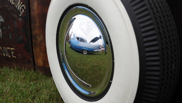 Charles Lambert’s 1955 Chevrolet 210 can be seen in the reflection of a rat rod’s chrome smoothie wheel at the inaugural Fast and Furry Car Show, which was held Saturday at the Butler County Fairgrounds. (Advocate Staff/Andy Brown)