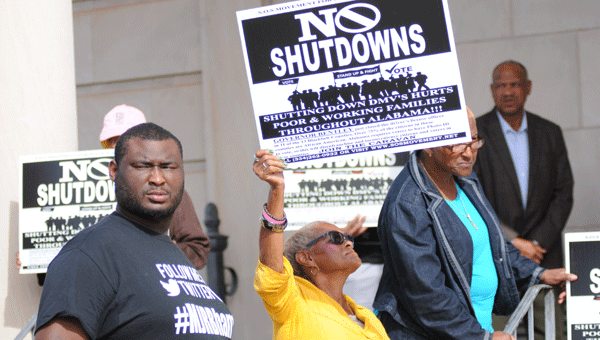 Protesters Joshua Raby and Bertha Nettles were two of several gathered in front of the Butler County Courthouse Thursday to express concern for the closing of 31 driver's license offices throughout the state.