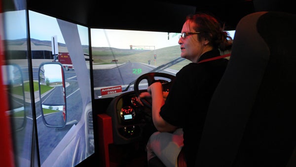 Butler County E-911 dispatcher Rosie Till learns what it’s like to guide an ambulance through traffic on the way to an accident scene. (Advocate Staff/Andy Brown)
