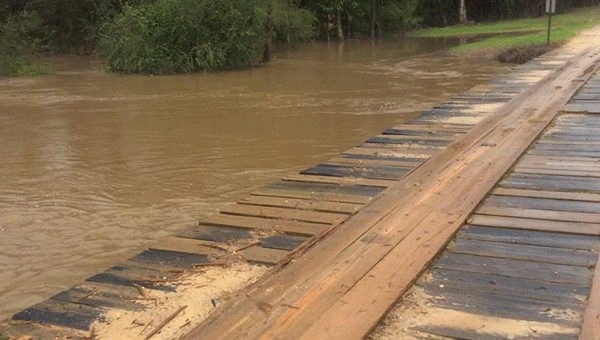 During the recent Christmas Eve and Christmas Day storms, all of Crenshaw County experienced torrential downpours that left many dirt roads and bridges out of commission. It was reported by Emergency Management Agency officials that within the span of 72 hours, Crenshaw County received 17 inches of rain.  Small creeks such as the one running under Swanner Bridge Road (pictured) were more than twice their original size by the time the storms subsided. (Courtesy photo) 