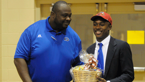 Georgiana head football coach Ezell Powell presented Jacquez Payton with a parting gift upon signing to Jacksonville State University.
