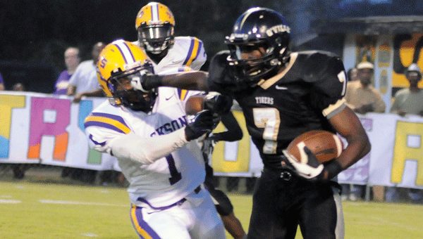 GHS alumnus Terail Snipes stiff-arms a would-be tackler after coming down with an interception during the Tigers’ postseason faceoff with the Jackson Aggies in 2013.
