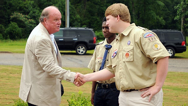 Boy Scout Warren Matthews, right, receives a handshake and a thank you from Greenville Mayor Dexter McLendon, left, during Monday's dedication ceremony of Stephenson Park. Matthews spearheaded the effort to revamp the park, which is found at the entrance of the Greenville YMCA. (Advocate Staff/Andy Brown)