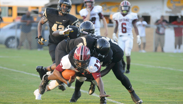 A host of Tigers pile on top of Mustangs wide receiver Jeremy Powers in the backfield for a loss during Greenville’s 13-7 victory over Stanhope Elmore.
