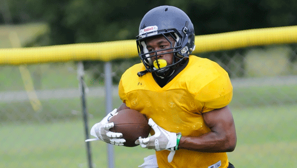 McKenzie running back Chris Shufford takes a handoff during the Tigers’ Thursday afternoon practice.  Shufford looks to reprise his role as one of the most dangerous backfield threats in the county this fall.