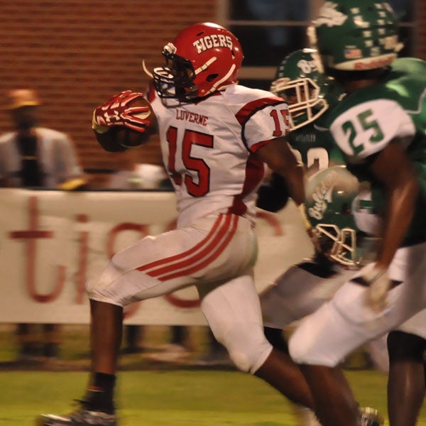 LHS junior running back Marcus McGhee escapes the cluthches of the BHS Bulldogs (Photo by Beth Hyatt). 