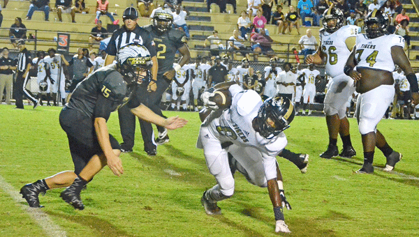 Jadavion Posey narrowly avoids a Wetumpka defender during the Tigers' 41-19 loss to the Indians.